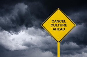 Picture of a warning sign that says, "Cancel Culture Ahead." The background is a dark, stormy sky.